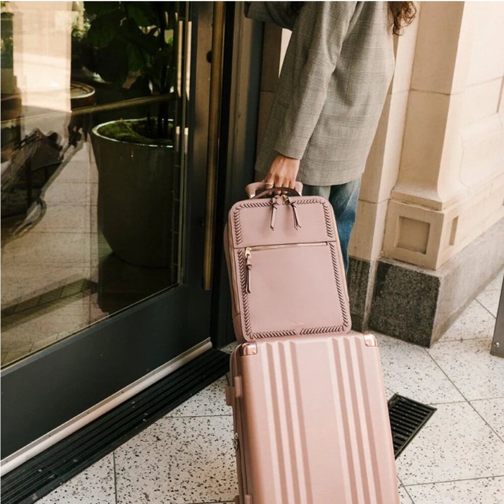 Calpak Pink Laptop Backpack with Whipstitch Detailing and Tassel Charm